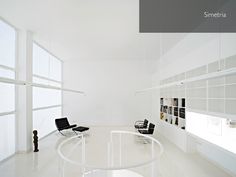 an empty room with white walls and chairs