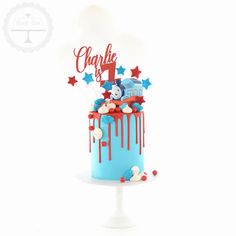 a blue cake with red, white and blue icing on it that says charlie 1