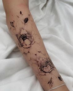 a woman's arm with flowers on it