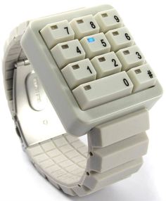 a wrist watch with an electronic keyboard on it's side and numbers in the middle