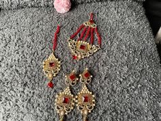 red wedding set. set includes tikka jhumar earrings Red Tikka With Intricate Design For Festive Occasions, Elegant Red Bridal Earrings With Stone Work, Red Temple Jewelry Tikka For Gifts, Red Jhumkas With Intricate Design For Celebration, Red Chandbali Tikka With Intricate Design, Festive Red Jhumkas With Intricate Design, Festive Red Hand Set Jhumkas, Red Bollywood Tikka As Gift, Elegant Red Kundan Tikka