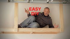 a man sitting in a window frame with the words easy diy on it