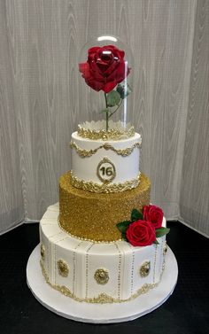 a three tiered cake with two roses on top