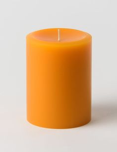 an orange candle on a white background