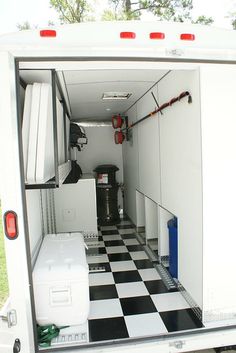 the inside of a white truck with black and white checkered floor