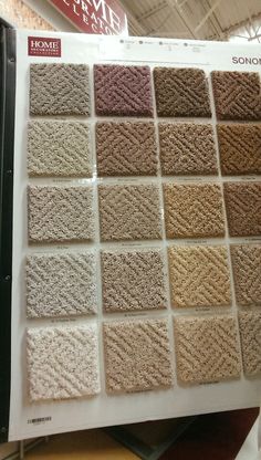 a bunch of carpet samples on display in a store