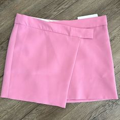 Flowy Fabric. Crossover Design. Short Design. Straight Design. Medium Waist. Button Fastening On The Front. Inner Lining. Co-Ord. College. Office Looks. Runs Big. I’m Usually A 4-6 Button Closure Chic High-waisted Pink Skort, Chic Spring Mini Skirt With Buttons, Chic Buttoned Mini Skirt For Spring, Pink Workwear Skirt With Buttons, Pink Buttoned Workwear Skirt, Chic Buttoned Skort For Spring, Pink Buttoned Skirt For Work, Chic Pink Skort, Chic Spring Mini Skirt With Button Closure