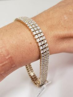 This Diamond Tennis Bracelet For Men in 10K Gold features a classic 3 row diamond tennis bracelet design miracle set in solid 10k gold. Total carat weight is 2.50 carats of round brilliant cut diamonds. Comes boxed ready to give.Mens 2.50ct Diamond Three Row Tennis Bracelet In 10k Yellow Gold Sparkle Factor: Excellent Diamonds: Genuine Round Brilliant Cut Diamonds in miracle settings Carats: 2.50ctw Color: H-I Clarity: I1-I2 Clasp: Hidden Box with Two Safetly Latches Weighs: 33.1 grams Width: 9mm Length: 9" closed Hallmarked: 10kt AV 100% Money Back / Satisfaction Guaranteed FREE gift box Mall Price: $11,475.00 092221.39171SHCS.UUAT.AV:228701Y Classic Iced Out Diamond Tennis Bracelet, Classic Iced Out Diamond Bracelet, Classic Iced Out Tennis Bracelet For Anniversary, Diamond Tennis Bracelet, Bracelet Design, Bracelet For Men, Tennis Bracelet Diamond, Gold Sparkle, Tennis Bracelet