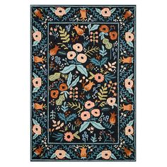 a blue rug with flowers and leaves on the border, in an ornate pattern that looks like