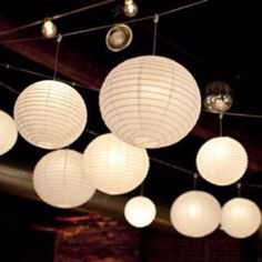 many white paper lanterns hanging from the ceiling