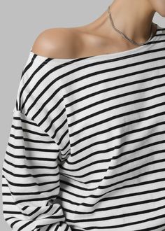 Color: Black Stripe Lightweight knit Relaxed fit Boat neck Drop shoulders Off the shoulder functionality Long sleeves Unlined 100% Cotton Machine Wash Cold By The Frankie Shop. Imported Chic Black Boat Neck Top, Lightweight Knit, Boat Neck, Black Stripes, Drop Shoulder, Off The Shoulder, Stripes, Relaxed Fit, Long Sleeves