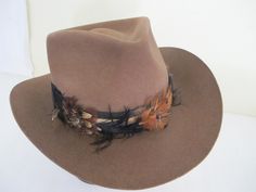 "Vintage Tiger of Sweden Outback Style Hat Made by Gil Truedsson Out of a ranch here in the Sierra's Top notch. For your steppin' out hat... Spectacular and extraordinary hat for the stylin' guy 5\" high 3\" brim. Feather hat band 23\" The color is a beautiful brown White satin lining Interior band is leather Excellent condition...barely worn Don't miss this one! Sharp! https://www.etsy.com/shop/BelindasStyleShop" Cowboy Hat Feather, Cowboy Hat Brown, Feather Hat Band, Vintage Cowboy Hat, Kliban Cat, Headband Hat, Velvet Cape, Vintage Tiger, Vintage Goth