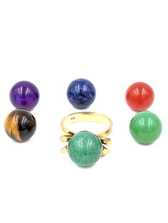 18k Interchangeable Gemstone Orb Ring - Gold Modernist Sphere Ring - Atomic Age Orb Ring - Amethyst Orb - Carnelian Orb - Tiger's Eye Orb ring in size 6 and re-sizable by your jeweler. What a special and fantastically rare piece of Atomic Age jewelry from the late 1960's to early 70's in great condition. A unique mod form design in 18k Yellow Gold with center screw for holding the gemstone orbs with 4 lobes extending above each shoulder. There's 6 12mm genuine gemstone orbs that have gold inner Luxury Yellow Gold Rings With Natural Stones, Yellow Gold Multi-stone Cabochons For Gift, Luxury Rings With Natural Stones, Formal Natural Stones Gemstone Ring, Yellow Gold Rings With Natural Stones, Sphere Ring, Ringe Gold, Atomic Age, Loose Stones