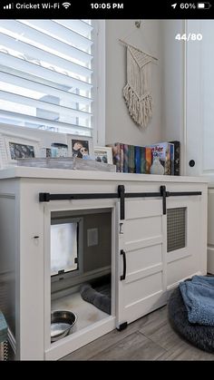 a dog house with the door open to reveal a cat bed in it's place