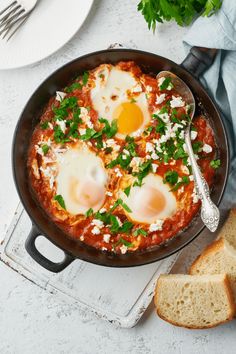 three eggs are on top of an omelet in a pan with parsley