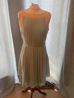 Gorgeous mint green vintage style dress with beige neckline & arm area Pleated design 'Darling' brand Size 8 Great condition Formal Beige Pleated Mini Dress, Elegant Light Green Mini Dress For Party, Chic Fitted Sage Dress, Elegant Fitted Light Green Dress, Elegant Green Pleated Mini Dress, Chic Light Green Knee-length Dresses, Elegant Sleeveless Light Green Dress, Elegant Light Green Midi Dress For Party, Sage Sleeveless Fitted Dress