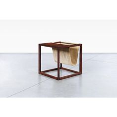 a small wooden table with a square shaped object on it's top and bottom