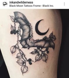 a bat and moon tattoo on the thigh