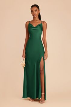 a woman wearing a green dress with a slit