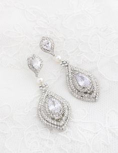 "Luxury Victorian Style Bridal Earrings made with CRYSTALLIZED™ - Swarovski Pearls. Make a statement with these beautiful pearl and crystal earrings! Long silver plated earrings feature sparkly cubic zirconia Teardrops. The earrings are made of Silver plated settings encrusted with tiny crystal rhinestones. Post is attached to the dangle setting with Swarovski pearls. The cubic zirconia teardrops measure about 12 mm (1/2 inch) and the whole earrings about 3\" (76 mm) in total length. Pictured on White Crystal Embellished Bridal Earrings For Wedding, White Crystal Embellished Wedding Earrings, Glamorous Hand Set Bridal Earrings For Wedding, White Crystal Embellished Earrings For Anniversary, Glamorous Hand-set Wedding Earrings, Glamorous Hand Set Earrings For Wedding, Crystal Embellished Drop Bridal Earrings, Crystal Embellished Drop Bridal Earrings As Gift, Crystal Embellished Drop Earrings For Wedding