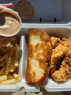 a foam container filled with fried chicken and french fries