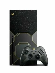 a black and gold xbox game controller next to a box with space in the background