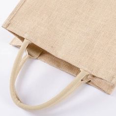 a beige bag sitting on top of a white table