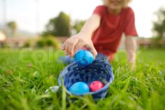 This eye-catching Easter basket is a little boy's treasure trove. He smiles as he adds one more egg that he found in the grass. Hand Images, The Grass, Easter Basket, Easter Baskets, Egg, Festival