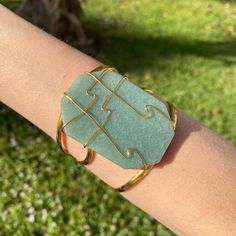 Step Up Your Style Game With This Oversized Encased Green Quartz Cuff Bracelet. Perfect For Those Who Love To Take Risks And Stand Out, This Eye-Catching Accessory Will Add A Flair Of Boldness And Challenge To Any Look! Made Of: Green Quartz 18k Gold Plating (2 Microns) Over Brass Made In Brazil Disclaimer: Please Note That All Semiprecious Stones Have Imperfections And Are Part Of Their Own Beauty. Due To Changes In Lighting, A Product May Appear Different In Pictures Than It Does In Real Life. Hand Wrapped Cuff Bangle Bracelet As Gift, Modern Green Cuff Bracelet As Gift, Green Cuff Jewelry For Gifts, Gold Hand Wrapped Cuff Bracelet As Gift, Hand Wrapped Gold Cuff Bracelet As Gift, Modern Green Cuff Bracelet For Gift, Modern Green Cuff Bracelet Gift, Gold Rectangular Cuff Bracelet Gift, Gold Wire Wrapped Cuff Bracelet Gift