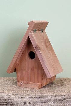 a wooden bird house sitting on top of a couch