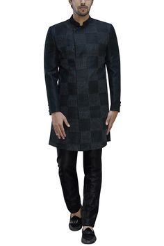 Black angrakha style sherwani which checkered stitchline embroidery. Paired with silk trousers.
Components: 2
Fabric: Silk
Neckline: Mandarin
Sleeve Length: Full
Color: Black
Embroidery
Embellished button front
Buttoned cuffs
Side slits
Trousers with belt loops
Closure: 
Kurta: Concealed button placket
Trousers: Hook front with zip - Aza Fashions Black Angrakha, Embroidered Sherwani, Trousers With Belt, Angrakha Style, Black Embroidery, Silk Trousers, Manish, Fabric Silk, Embroidered Silk