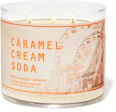 an orange and white candle with the words caramel cream soda on it's front