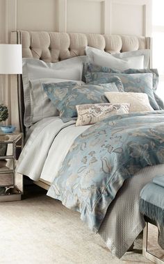 a bed with blue and white comforters in a bedroom