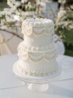 a wedding cake sitting on top of a white table