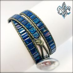 two bracelets with blue glass beads are on display