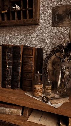 there are many old books on the shelf next to each other, including one with an antique clock