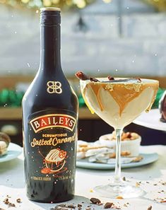 a bottle of bailey's chocolate caramel liqueur next to a dessert