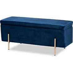 a blue velvet bench with gold legs