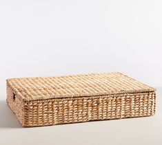 an empty wicker box on a white background with no people in the room around it