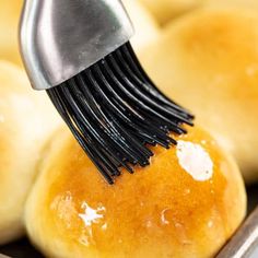 a close up of bread being brushed with a brush