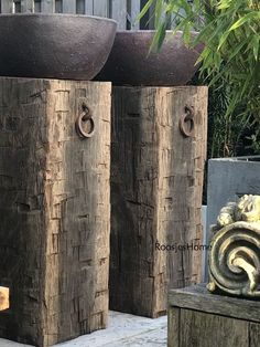 two large wooden vases sitting on top of each other