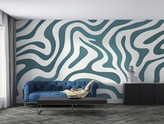 a living room with a blue couch and zebra print wallpaper on the walls behind it