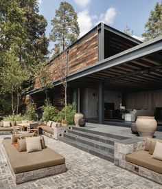 an outdoor living area with couches and tables