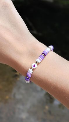 This super cute clay bead bracelet is made with high quality beads. It has the colors: -dark purple -light purple -white.  There is a heart bead in the center. The pattern is ombre from dark purple to light purple to white. each pattern is separated by a gold spacer bead. Please note that colors and pattern may vary from each bracelet. All bracelets vary from 6.5 inches to 6.75 inches.  While the string I use is high quality, be careful not to overstretch the bracelet as it will shorten its lifespan. In addition, keep out of water as it will shorten the lifespan of the bracelet. Excessive sweating and water exposure may also rust any gold beads if there are any gold beads on the bracelet.  WARNING: keep out of reach of children as this product is a choking hazard. 🚨HOW TO GET BUY 4 GET ON Light Purple Clay Bead Bracelet, Purple Heart Beads Stretch Bracelet, Adjustable Purple Beaded Bracelets With Heart Beads, Purple Heart-shaped Beaded Bracelets For Gifts, Purple Heart-shaped Beaded Bracelets Gift, Purple Heart Beaded Bracelets, Purple Beaded Bracelets With Heart Beads For Gifts, Cute Everyday Purple Bracelet, Cute Purple Everyday Bracelet