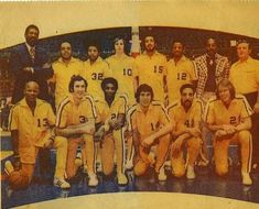 an old photo of men in yellow uniforms posing for a team photograph on a tennis court