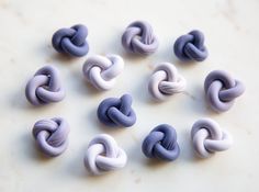 there are many different colors of beads on the table, one is blue and white