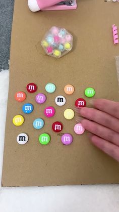 a person is making letters out of buttons