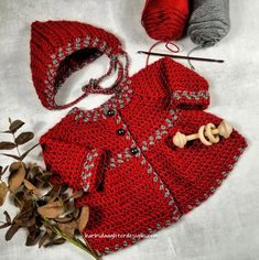 a crocheted red coat, hat and yarn