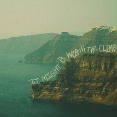 the word worth the climb is written in white on top of a cliff above water