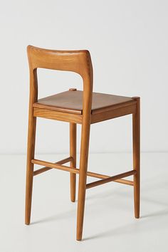 a wooden chair sitting on top of a white floor